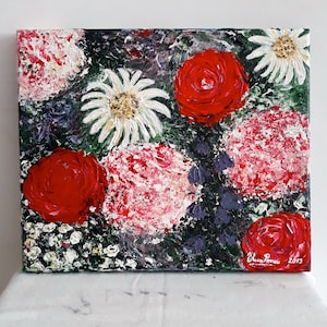 May include: A colorful oil painting on canvas featuring a bouquet of red, white, and pink flowers. The flowers are painted in a loose, expressive style, with visible brushstrokes. The background is a dark green, with hints of purple and blue.