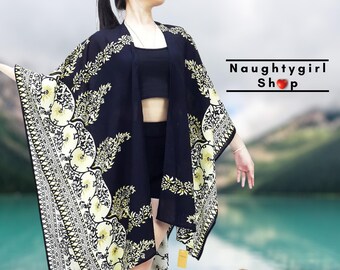 May include: A black and gold floral print kimono with a long, flowing silhouette. The kimono has a wide, open neckline and is made of a lightweight fabric.
