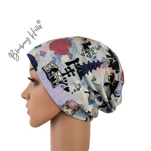 May include: A grey beanie with a Japanese-inspired print featuring a pagoda, cherry blossoms, and other designs. The beanie is made of a soft, stretchy fabric.