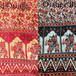 May include: Two fabric swatches with an Indian-inspired design featuring elephants, arches, and floral patterns. The left swatch is red and orange, while the right swatch is orange and black.