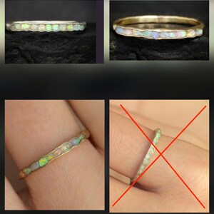 May include: A thin metal ring featuring a continuous channel inlay of small, iridescent, multi-coloured opal stones. The band has a slightly wavy, organic edge profile that follows the shape of the embedded stones along the outer circumference.