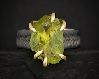 Raw Peridot Ring. Rustic Mixed Metal Gold and Black Silver Prong Set Raw Uncut Natural Peridot Statement Large Stone Feather Rebel Ring