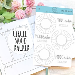 May include: A sheet of white sticker paper with three black and white circle mood trackers. Each tracker has a circle with lines radiating from the center and the text "MOODtracker" printed above the circle. The text "F746" is printed in the top left corner of the sheet.