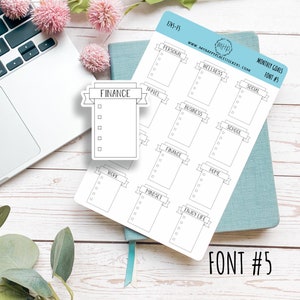 May include: A sheet of white sticker paper with 12 different monthly goal stickers. Each sticker has a banner with a category name and a checklist with five blank boxes. The categories are: Personal, Wellness, Social, Travel, Business, School, Finance, Home, Work, Mindset, and Enjoy Life. The text "MONTHLY GOALS FONT #5" is printed in the top right corner of the sheet.