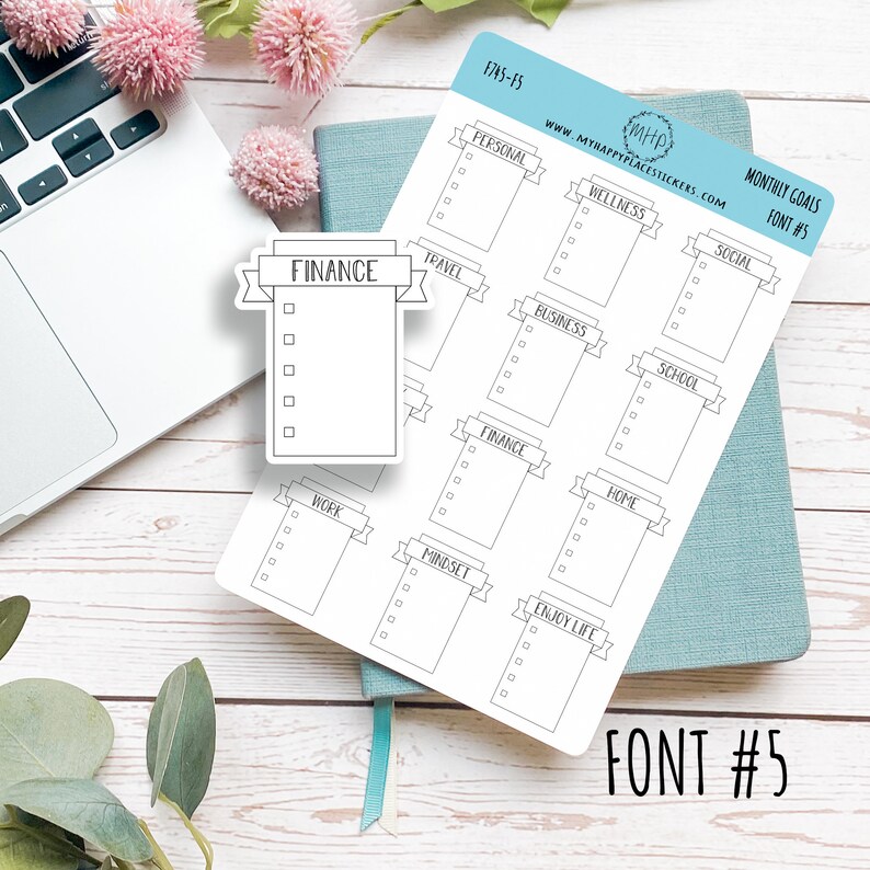 May include: A sheet of white sticker paper with 12 different monthly goal stickers. Each sticker has a banner with a category name and a checklist with five blank boxes. The categories are: Personal, Wellness, Social, Travel, Business, School, Finance, Home, Work, Mindset, and Enjoy Life. The text "MONTHLY GOALS FONT #5" is printed in the top right corner of the sheet.