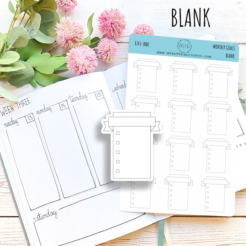 May include: A sheet of blank monthly goal stickers with a banner design. The stickers are white with black outlines and are printed with the text "MONTHLY GOALS BLANK".