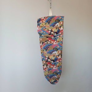 tassenopberghouder met klep. Zakjesdispenser. Keuken opslag. Veelkleurige stof. Keukeninrichting