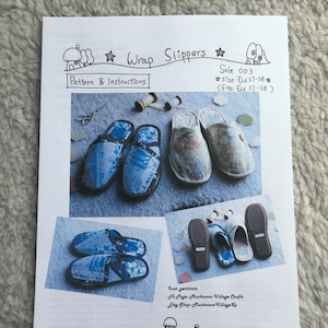 May include: A printable pattern for making wrap slippers. The pattern includes instructions and a diagram of the slippers. The slippers are made of fabric and have a blue and white patterned design. The pattern is for size EU 37-38.