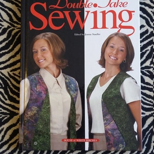 May include: A book titled "Double Take Sewing" edited by Jeanne Stauffer. The book cover features two women wearing vests with a colorful floral pattern. The book is published by House of White Birches.