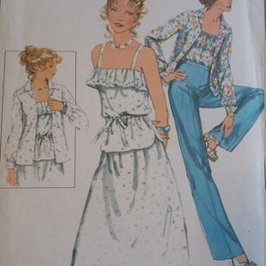May include: A vintage sewing pattern featuring three different outfits. The first outfit is a white sleeveless top with a ruffled neckline and a matching skirt. The second outfit is a white top with a ruffled neckline and a matching skirt. The third outfit is a blue and white patterned top with a blue pair of pants.