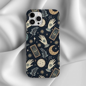 May include: A phone case with a dark blue background featuring a repeating pattern of hands, moons, stars, and tarot card designs. The case has a glossy finish and a cutout for the camera.