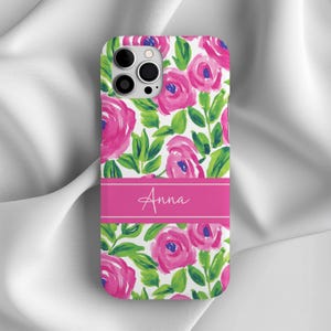 May include: A pink and green floral phone case with the name "Anna" printed in white on a pink stripe.