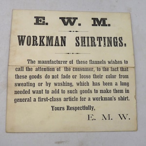 May include: A vintage advertisement card for "WORKMAN SHIRTINGS" with the initials "E. W. M." at the top and bottom. The text highlights the colorfastness of the flannels and is addressed to the consumer.