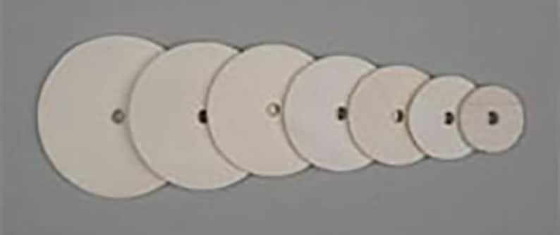 May include: A set of eight white round sanding discs of varying sizes.