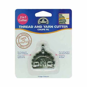 May include: A silver thread and yarn cutter with the DMC logo on it. The cutter is packaged on a white card with the text "2 in 1 Cutter", "Thread and Yarn Cutter", "Coupe Fil", "Vos Voyages Safe for Travel", "For Cutting All Types of Threads", "Coupe tous types de fils", "For Cutting Yarns and Heavy Fibers", "Coupe les fils epais", and "Vintage Collection".