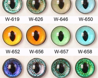 May include: A collection of twelve glass eye cabochons in various colors, including green, blue, yellow, and orange. Each eye has a black pupil and is labeled with a "W-" followed by a number. The eyes are round and have a glossy finish.