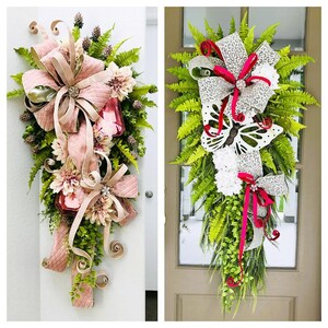 May include: Two door wreaths with pink and white bows, greenery, and flowers. One wreath has a pink bow and the other has a white bow with a butterfly.