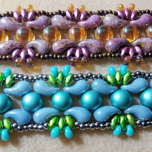 May include: Close-up of two beaded bracelets. The top bracelet features purple and gold beads, while the bottom bracelet showcases blue and green beads. The bracelets are intricately designed with various shapes and sizes of beads, creating a textured and colourful accessory.