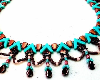 May include: A beaded necklace featuring turquoise, copper, and dark brown elements. The necklace has a repeating pattern of turquoise chevrons and copper-colored beads. Dangling teardrop-shaped beads in dark brown and smaller beads in pink and turquoise complete the design.