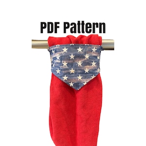 May include: A red hooded towel with a blue and white bandana-style hood featuring a distressed American flag pattern with white stars. The towel is hanging on a silver towel rack. The text "PDF Pattern" is displayed above the towel.