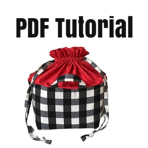 May include: A PDF tutorial for making a red and black checkered drawstring bag with a handle. The bag is made of fabric and has a drawstring closure.