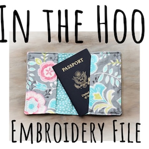 May include: A passport holder with a floral design in gray, pink, and blue, holding a United States passport. The text "IN THE HOOP" and "EMBROIDERY FILE" are displayed in black.