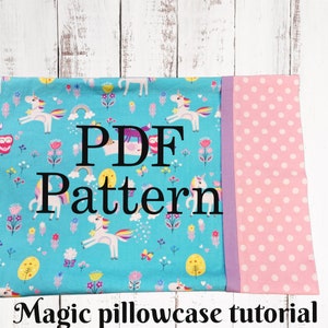 May include: A PDF pattern for a magic pillowcase tutorial. The pillowcase features a blue fabric with a unicorn and rainbow print and a pink fabric with white polka dots.