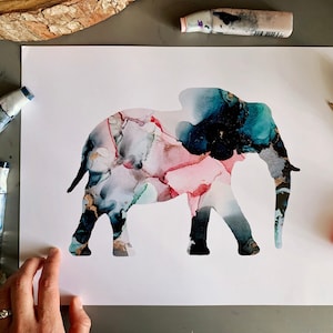 May include: An abstract painting of an elephant silhouette in shades of pink, blue, and gold. The painting is on a white background.
