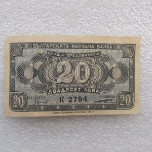 May include: A blue and white Bulgarian banknote with the text "БЪЛГАРСКАТА НАРОДНА БАНКА" and "ПЛАЩА ПРЕДЯВИТЕЛЮ" at the top. The number "20" is printed in the center of the note, with the text "ДВАДЕСЕТ ЛЕВА" below it. The note also has the number "2794" printed on it.