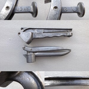May include: Two vintage silver garlic presses. The top press has a handle with a textured grip and the words "ЦЗ ВБ" stamped on the side. The bottom press has a smooth handle and the numbers "69-3" stamped on the side.