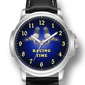 May include: A silver watch with a black leather band. The watch face is blue with white numbers and two white pigeons. The text "Racing Time" is printed on the watch face.