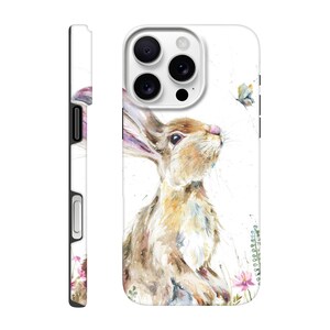 May include: A white phone case featuring a watercolor painting of a brown rabbit looking up at a butterfly. The case has a side view showing a black button and a floral design. The rabbit is surrounded by pink flowers and green foliage.