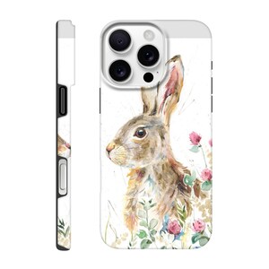 May include: White phone case featuring a watercolor illustration of a brown rabbit with long ears, surrounded by pink flowers and green foliage. The case has a white top and sides, with a black camera cutout and buttons.