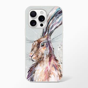 May include: A phone case featuring a detailed painting of a hare. The artwork showcases the hare's profile with brown, white, and pink fur, long ears, and a detailed eye. The case has a light gray border.