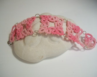 Tatted with egyptian cotton thread in shades of pinks with silver tone rings and clasp.