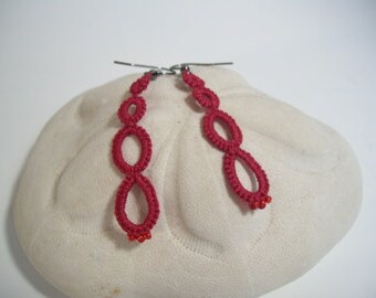 Four ring red tatted earrings.