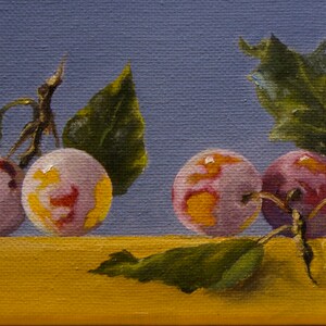 May include: A still life painting of plums with green leaves on a blue and yellow background. The plums are a light purple color with yellow and red highlights.