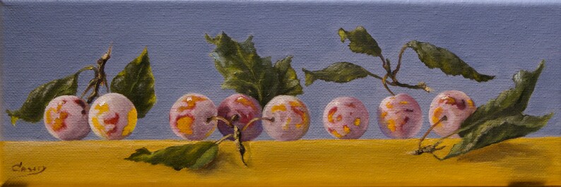 May include: A painting of seven plums with yellow and pink skin, arranged in a row on a yellow surface. The plums are surrounded by green leaves.