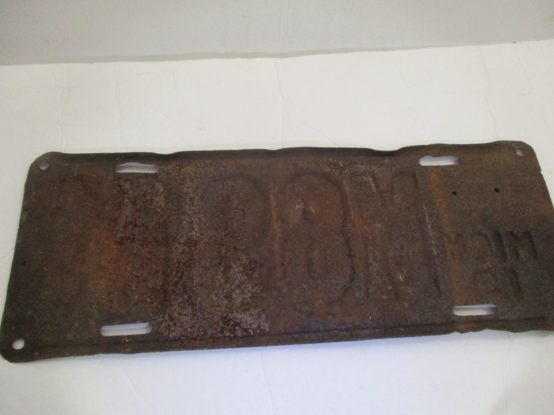 License plate is from 1911 Early Brass Age car license plate 10/% off was 200. is for Michigan and is # M89