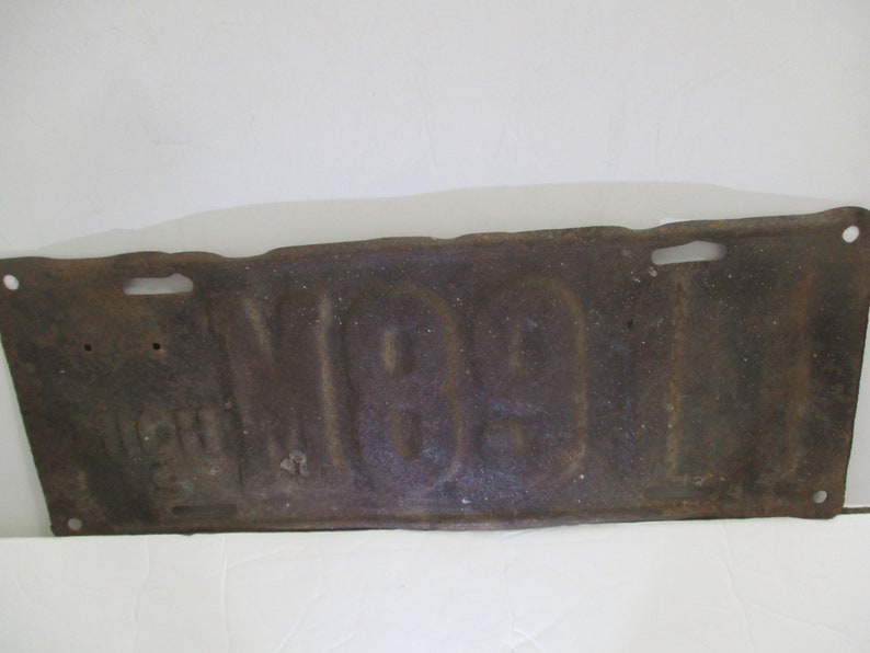 License plate is from 1911 Early Brass Age car license plate 10/% off was 200. is for Michigan and is # M89