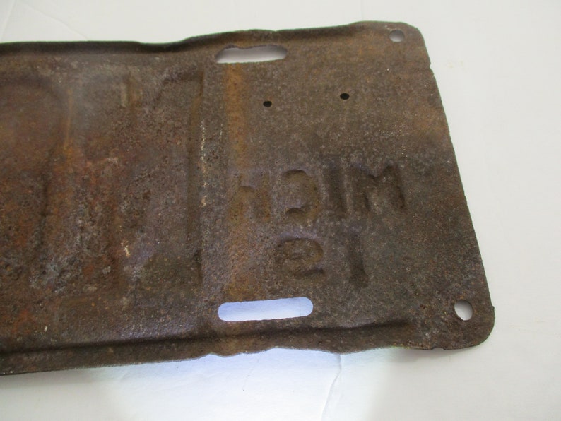 License plate is from 1911 Early Brass Age car license plate 10/% off was 200. is for Michigan and is # M89