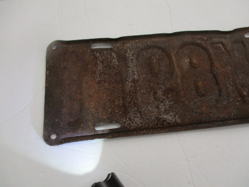 License plate is from 1911 Early Brass Age car license plate 10/% off was 200. is for Michigan and is # M89