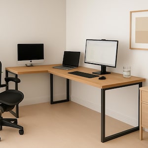 May include: A modern home office setup featuring a light wood L-shaped desk with black metal legs. A black ergonomic chair, two computer monitors, a laptop, and a small wooden cabinet are also present.