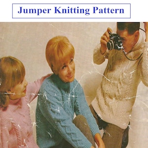 May include: Three people wearing knitted jumpers, two women and one man. The women are sitting on the floor, and the man is standing behind them. The woman in the centre is wearing a blue jumper with a cable knit pattern. The woman on the left is wearing a pink jumper with a cable knit pattern. The man is wearing a white jumper with a cable knit pattern. The image includes the text "C46".