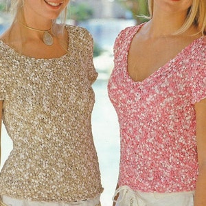 May include: Two women wearing short-sleeved tops. The top on the left is beige with white flecks. The top on the right is pink with white flecks.