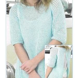 May include: A light blue open back tunic knitting pattern with the number K219 printed on the bottom.