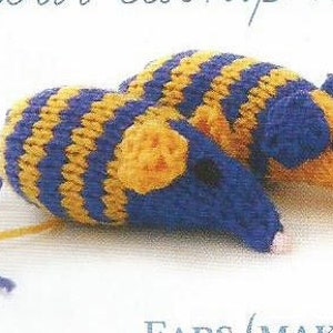 May include: Hand-knitted toy mice in blue and yellow stripes. The mice have blue heads, yellow ears, and pink noses. The tails are made of yarn. These soft toys are perfect for a child's play.