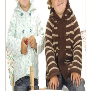 May include: Two children wearing knitted duffle coats. The child on the left is wearing a white coat with blue buttons and a floral pattern. The child on the right is wearing a brown and white striped coat with brown buttons. The image has the number 9 in the bottom center.