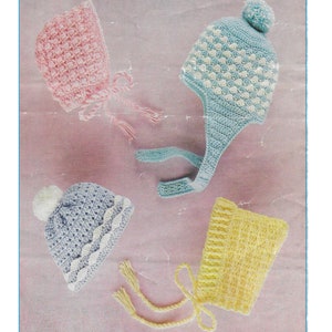May include: Four crocheted baby hats in pink, blue, and yellow. The hats have different styles, including a beanie with a pom-pom, a bonnet with ties, and a hat with a long flap. The hats are on a pink background. CB169