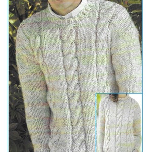 May include: A cable knit sweater pattern. The image shows a person wearing a light-colored cable knit sweater with a round neck. The sweater has a prominent cable design down the front. The text "Cable Jumper Knitting Pattern" is at the top.